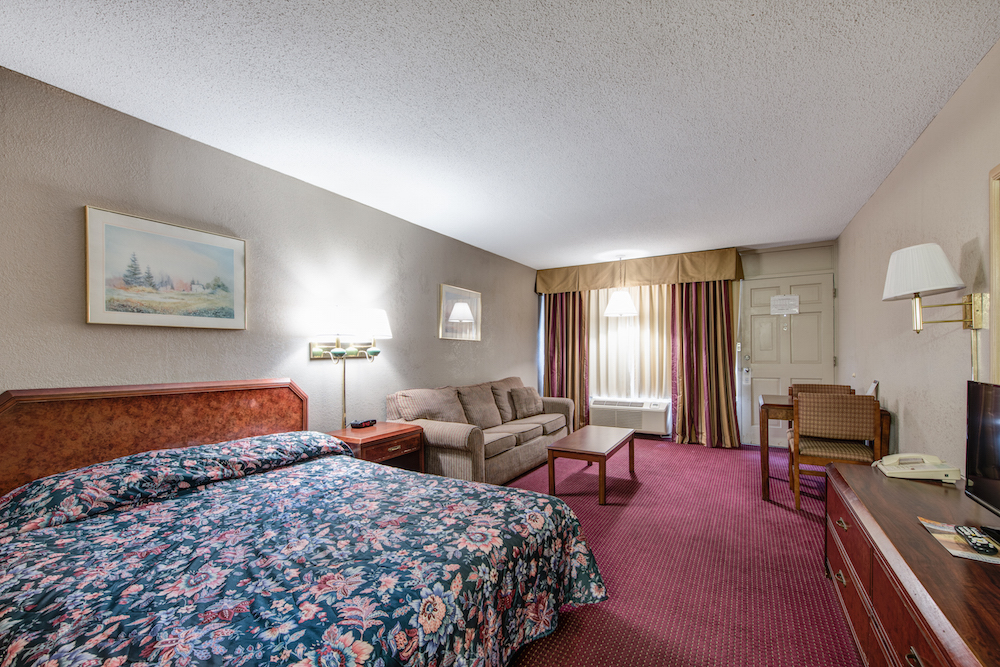 motel room with queen bed and sofa bed