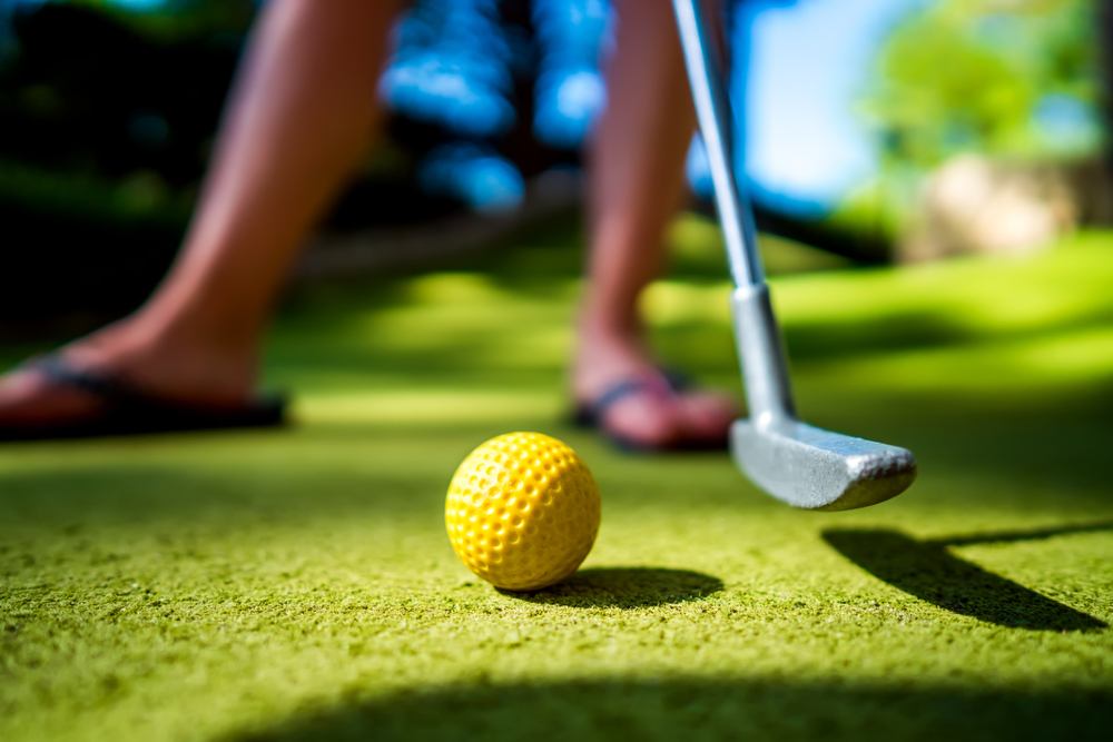 person playing mini golf